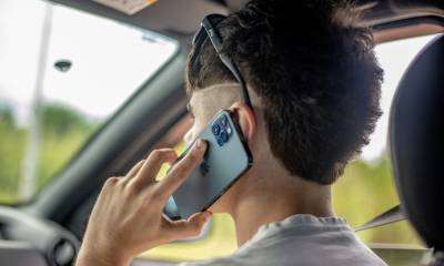 What counts as “using” a cell phone under the Motor Vehicle Act?